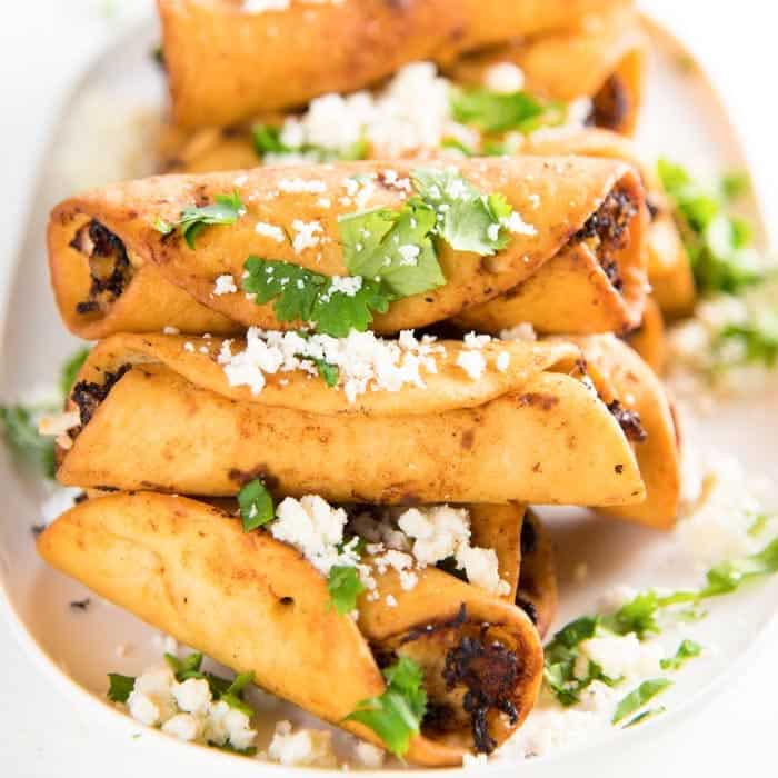 taquitos w cochita cheese cilantro and salsa